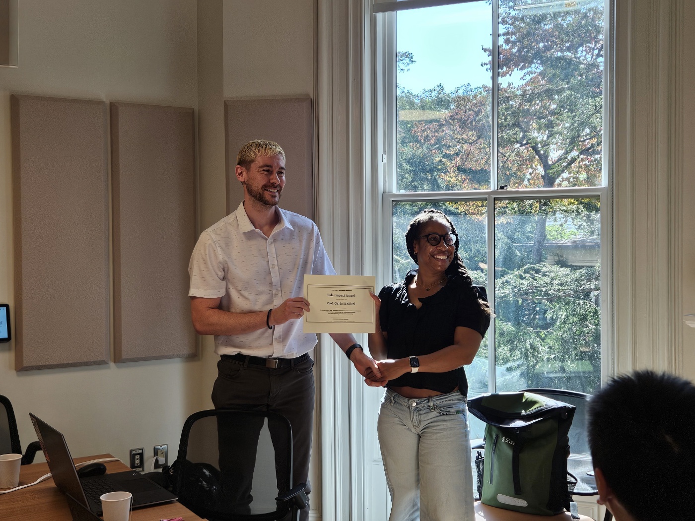 Gavin McNicol and a colleague holding a Yale Impact Award certificate.